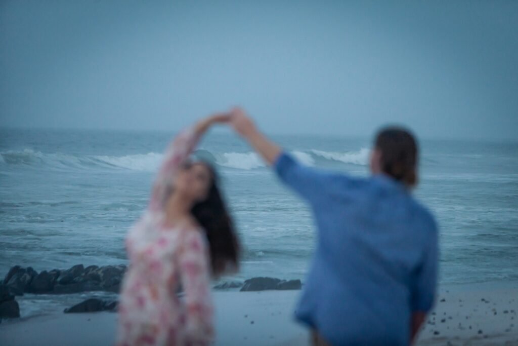 a man and a woman dancing on the beach
